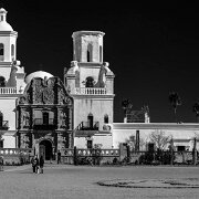 2018-03-23_32196_WTA_5DM4 - Panorama - 6 Images - 16228x6455_0000 Mission San Xavier del Bac is a historic Spanish Catholic mission located about 10 miles (16 km) south of downtown Tucson, Arizona, on the Tohono O'odham San...